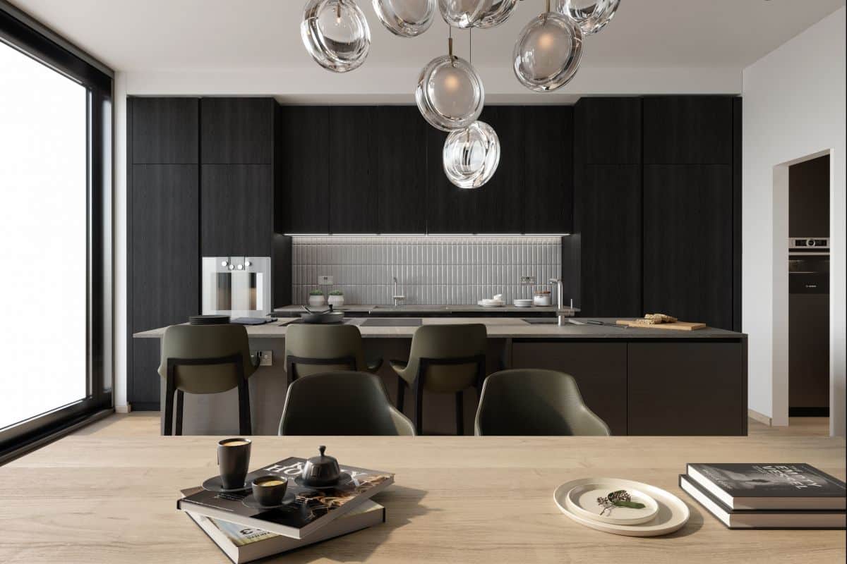 This high-end luxury kitchen seamlessly blends with the dining room. A dark wood kitchen island takes centre stage, featuring a grey marble surface top and a matching base that harmonises with the kitchen cabinets and joinery. A white tile splashback adds a touch of elegance. The light wood flooring complements the light wood dining table, creating a cohesive look. Dark green counter chairs with black legs echo the style of the dining chairs, providing a sophisticated and unified aesthetic throughout the kitchen and dining space.