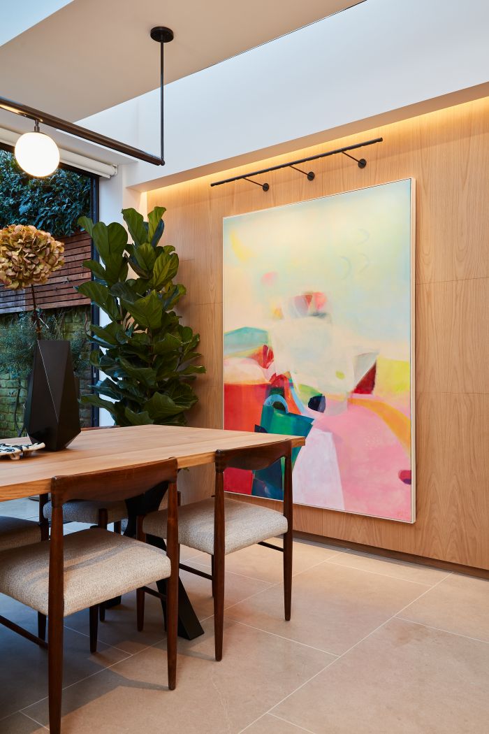 A natural wooden panelled wall in a kitchen dining room. 