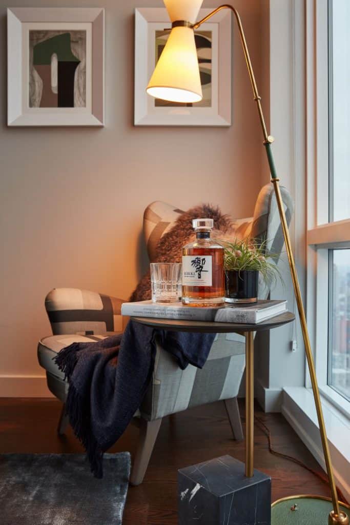 Relaxed seating area with wingback armchair in bedroom window.