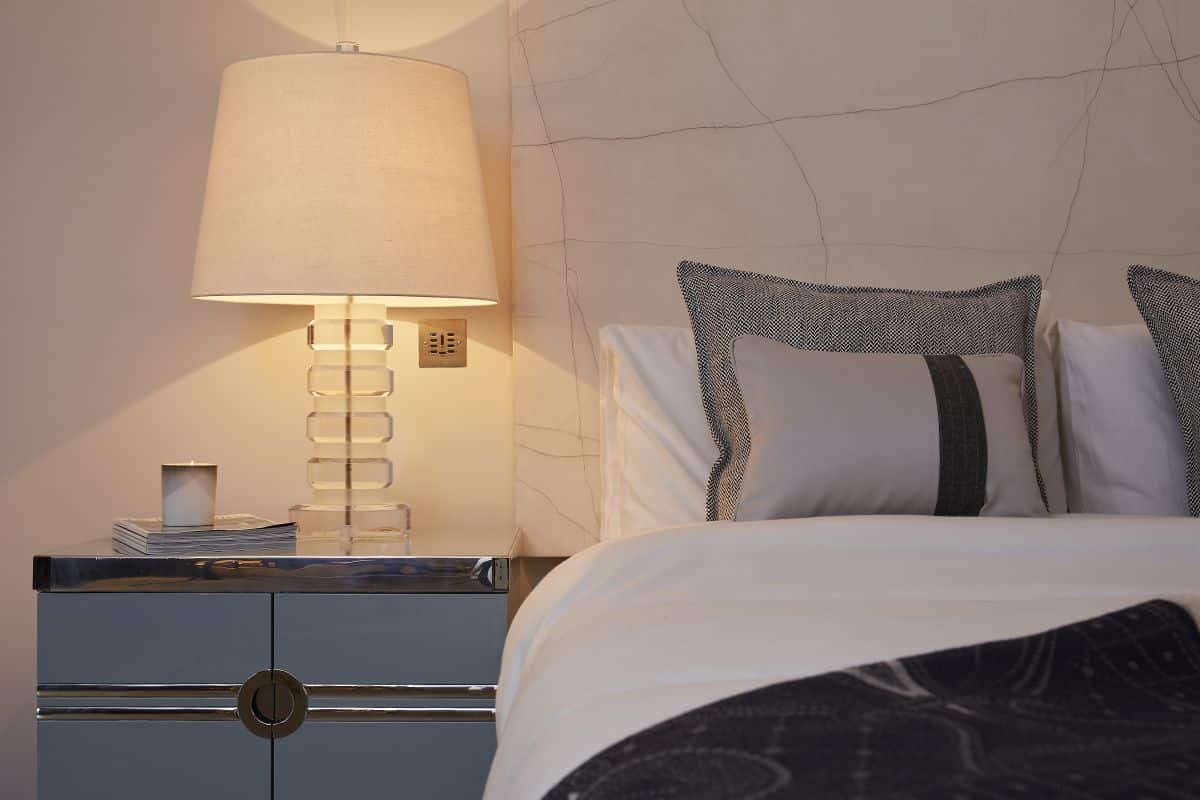 A cracked gesso piece of art used as a headboard in this principle bedroom. 