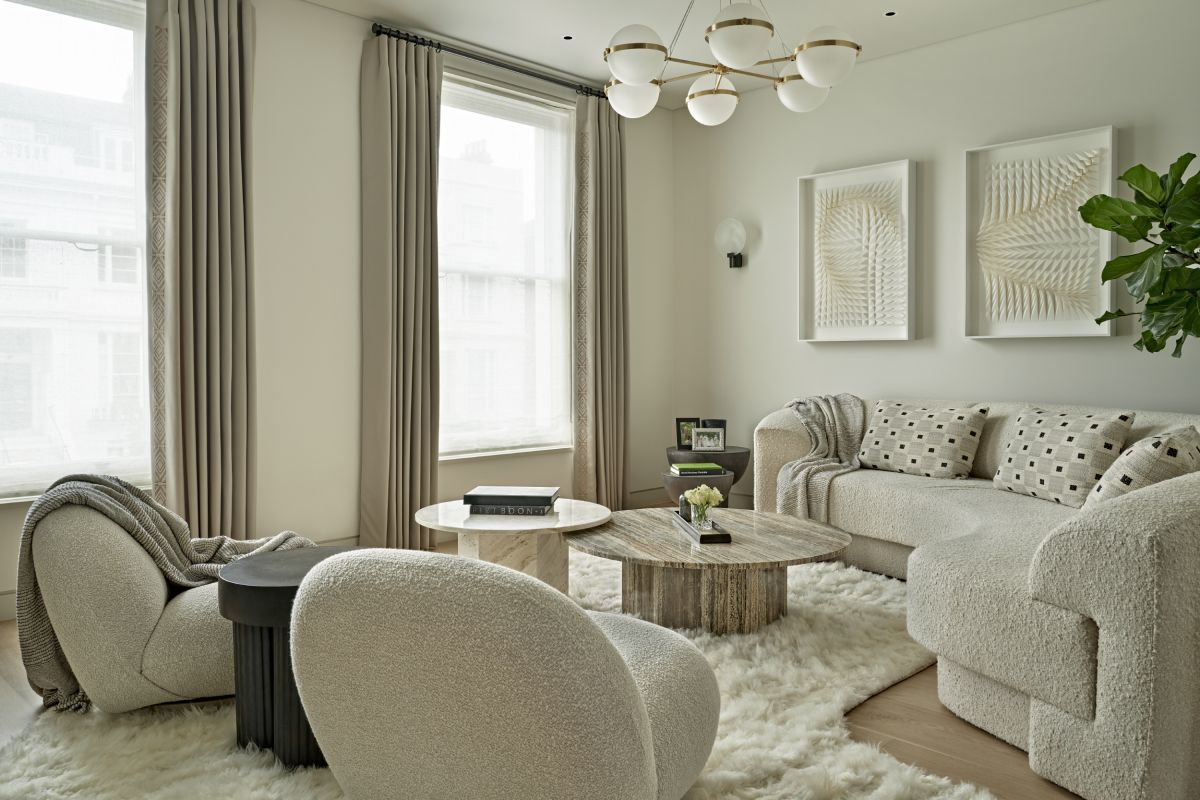 A pair of gubi pacha armchairs in boucle fabric in London drawing room. 