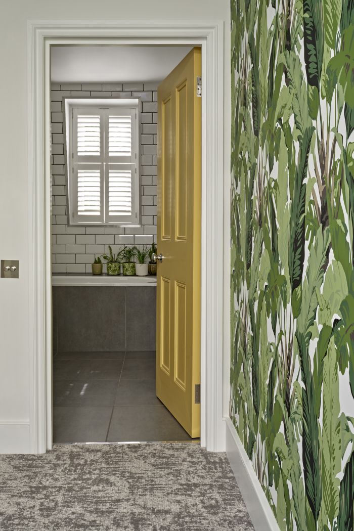 Bright patterned wallpaper in hallway. 