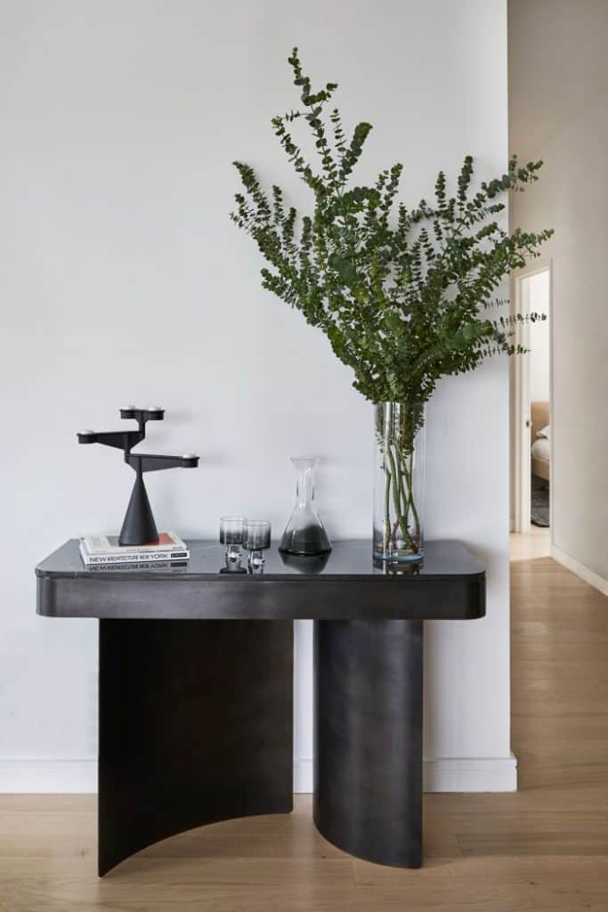 A kin and company crescent console creates a nice focal point in this dining room and hallway.