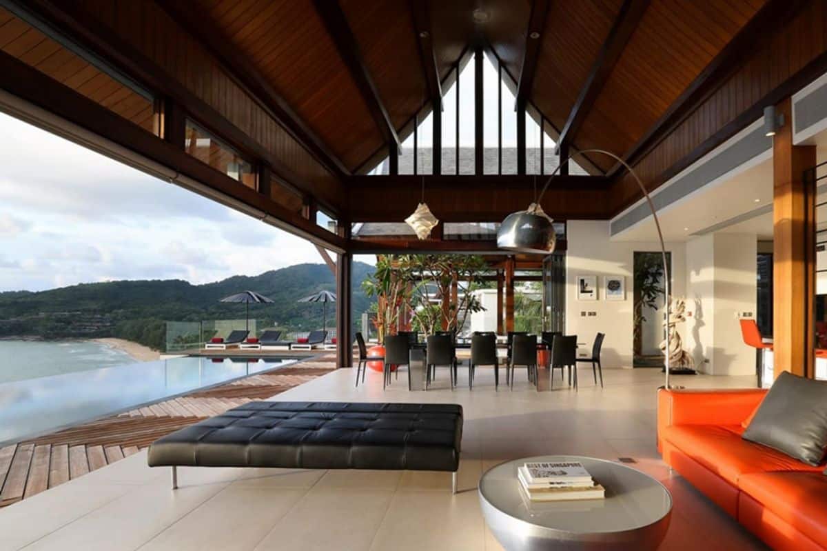 Large open plan living and dining room leading to deck with infinity pool and sea views. 