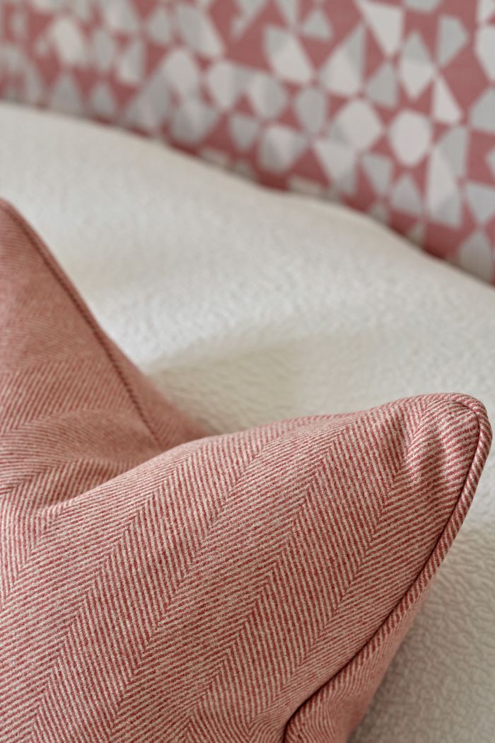 Layered cushions on a bed. 