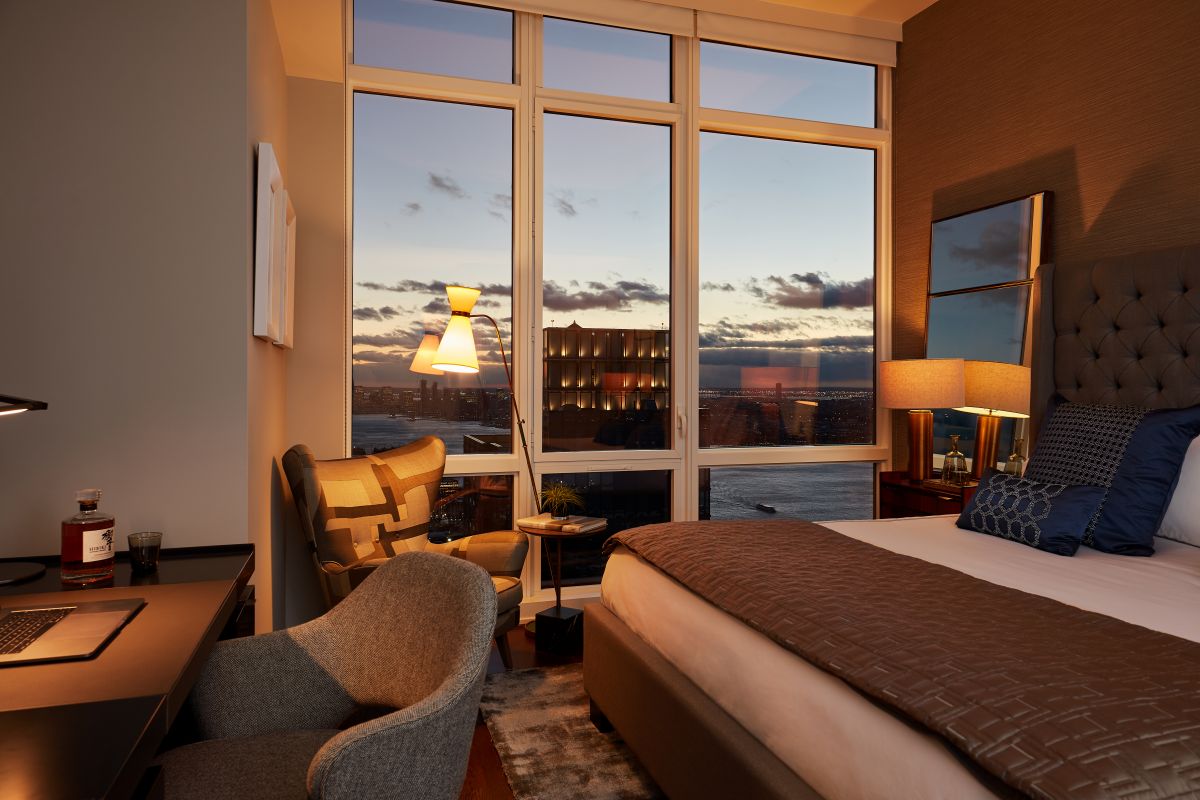 NYC penthouse with skyline views at night. 