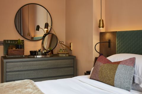 Teal vanity Table in pink bedroom with teal headboard.