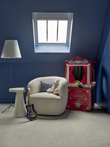 Kids reading area in blue boys bedroom.