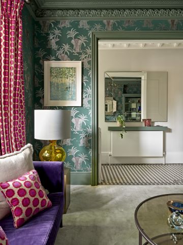 Eclectic colourful living room leading to a period entrance hallway.