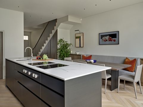 Open plan neutral kitchen and dining area.