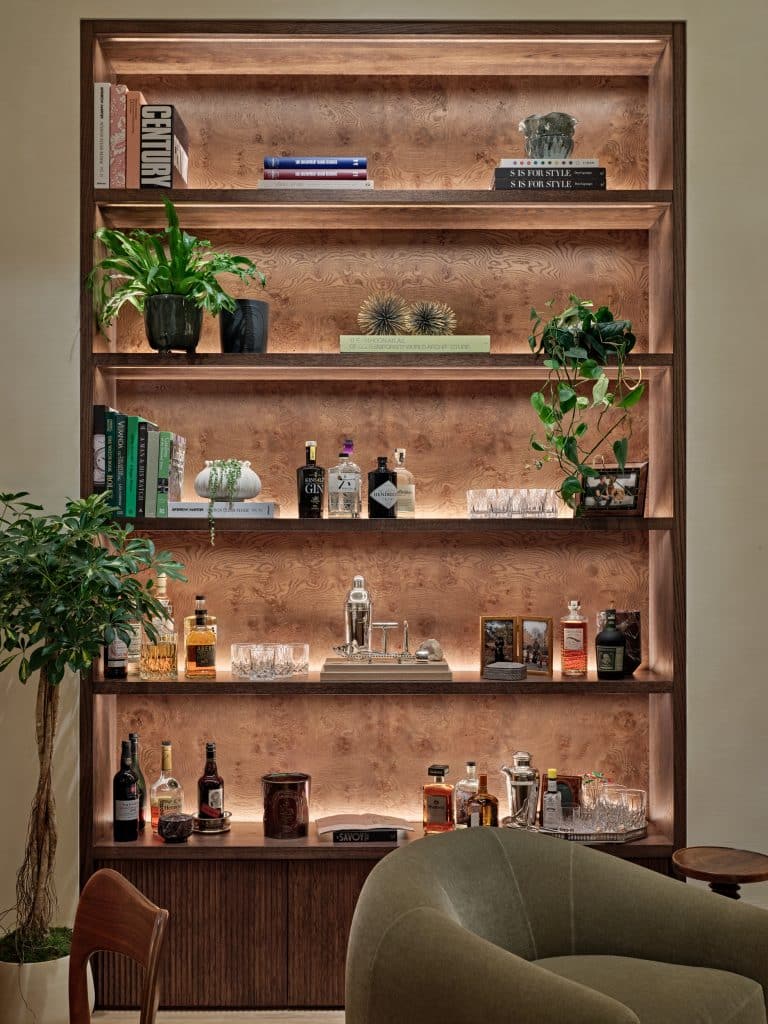 Wooden bespoke joinery in Central London flat. The joinery is lit up from the back with dimmable light to adjust to the natural lights.