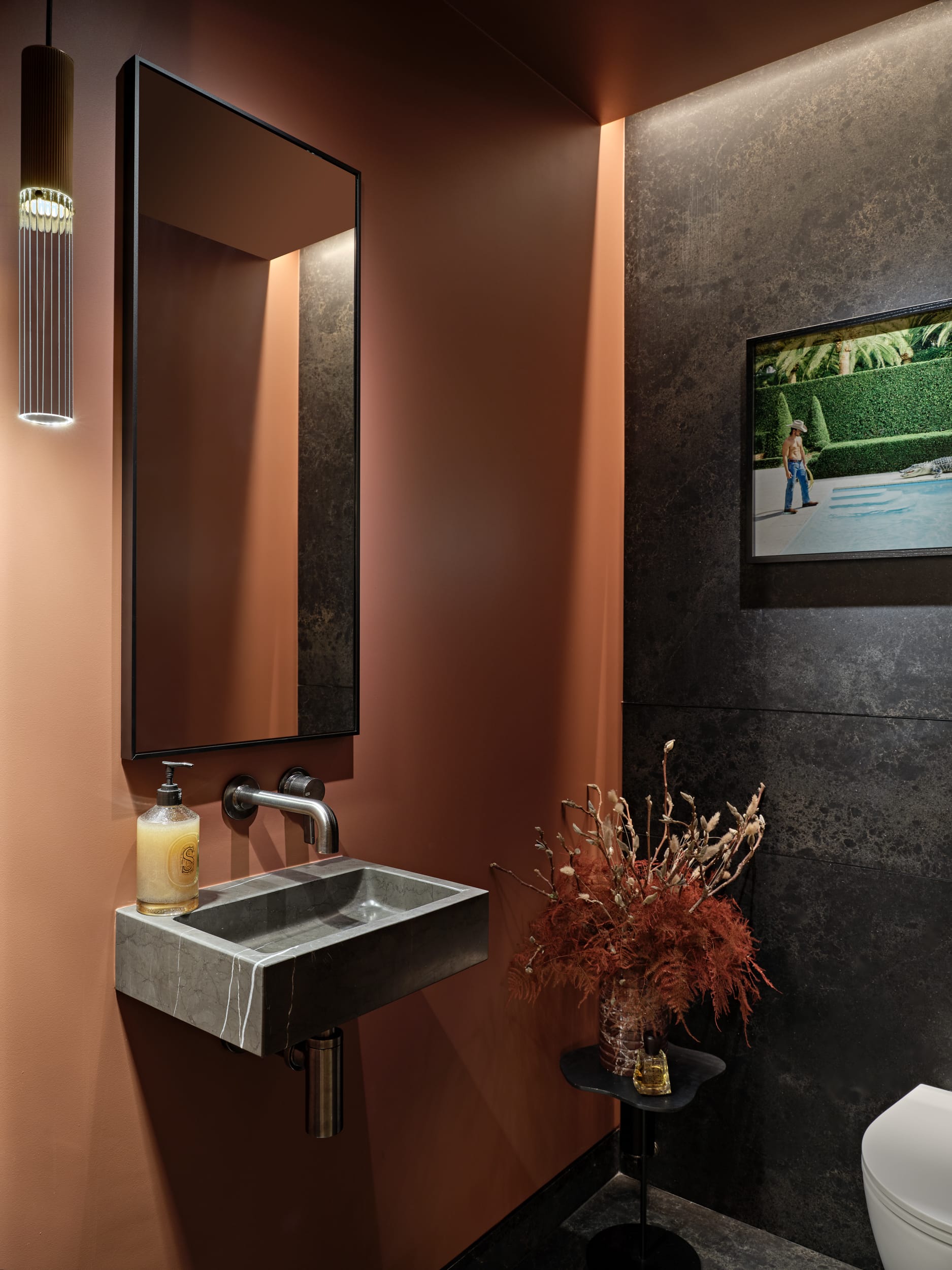 Moody, warm toned luxurious guest bathroom in Central London apartment.