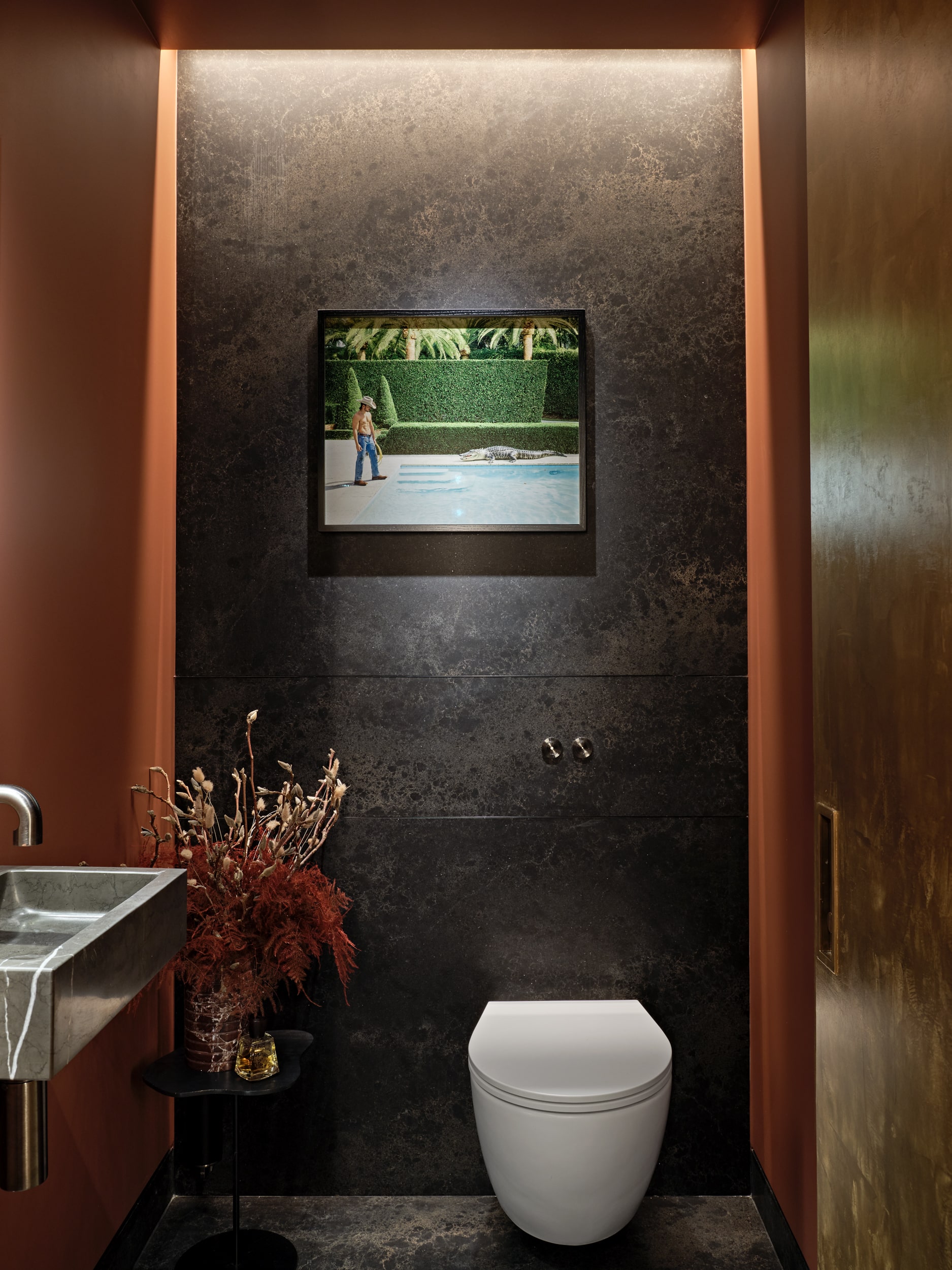 Moody, warm toned luxurious guest bathroom in Central London apartment.