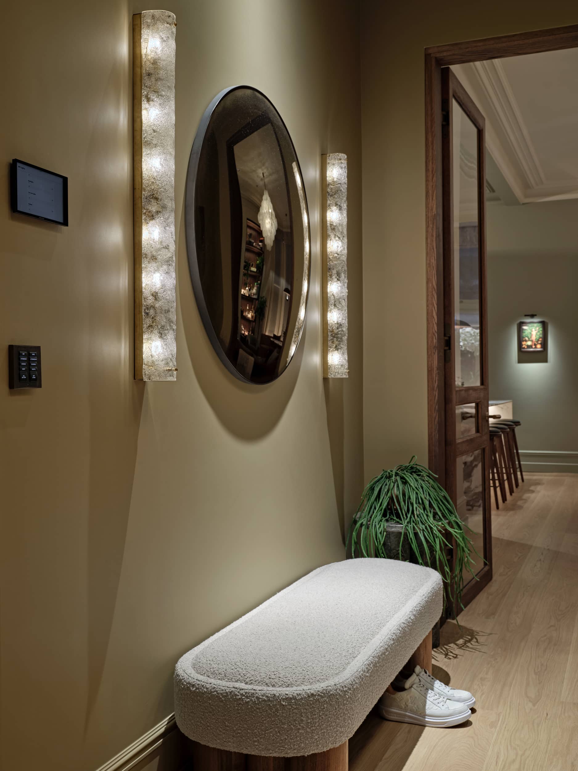 Hallway with Benjamin Rayond Decorative Atelier to give the wall paneling an elegant & luxurious finish.